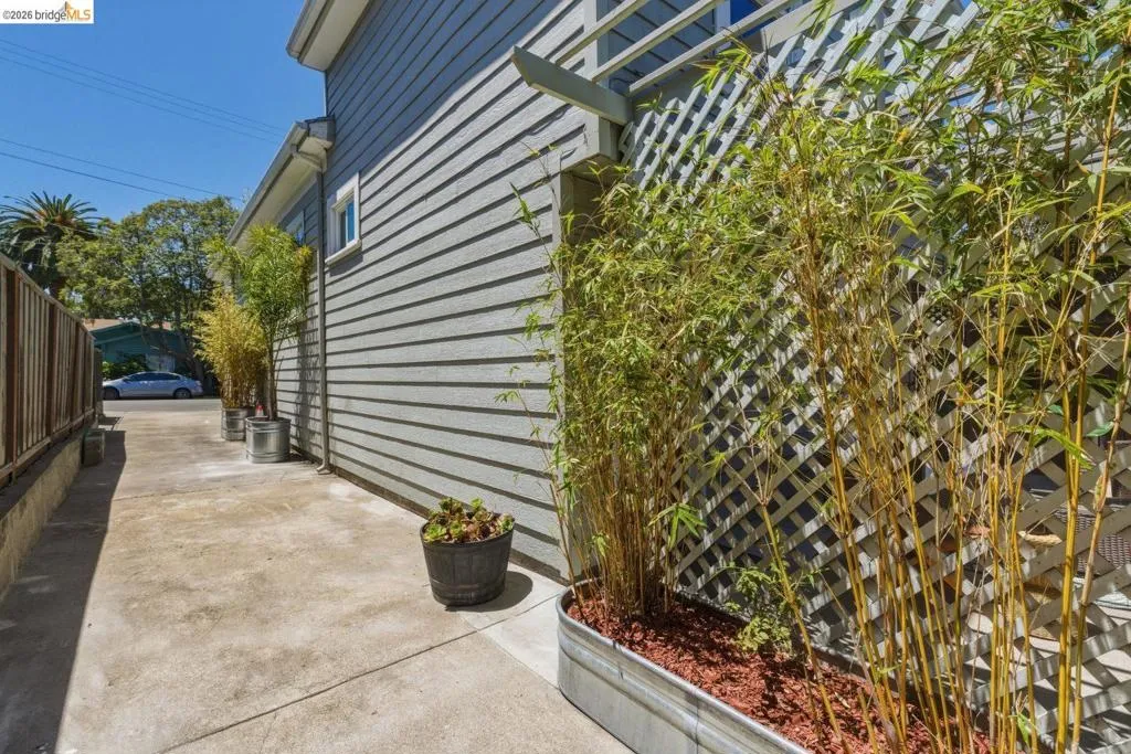Concrete pathway alongside a horizontal siding exterior
