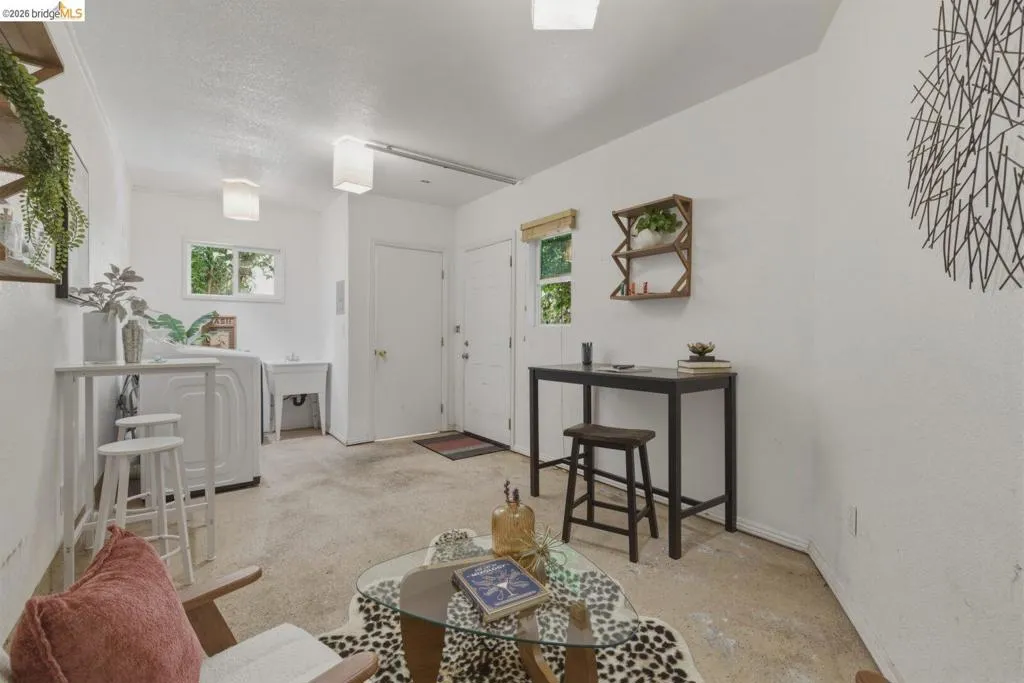 Utility space featuring a window, laundry hookups, and a utility sink