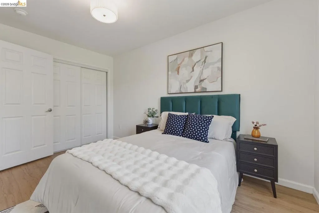 Light wood-finish flooring complements the neutral wall color