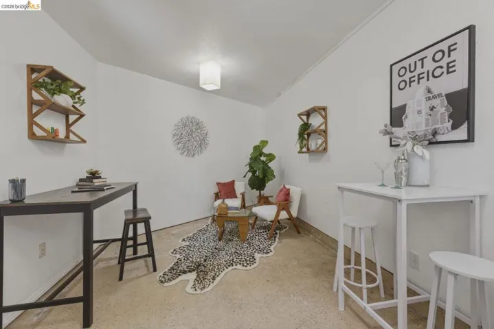 White walls and light-colored concrete flooring define this versatile space