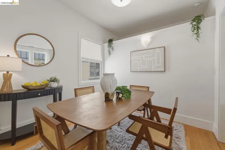 Dining area featuring wood-finish flooring, white walls, and a recessed window