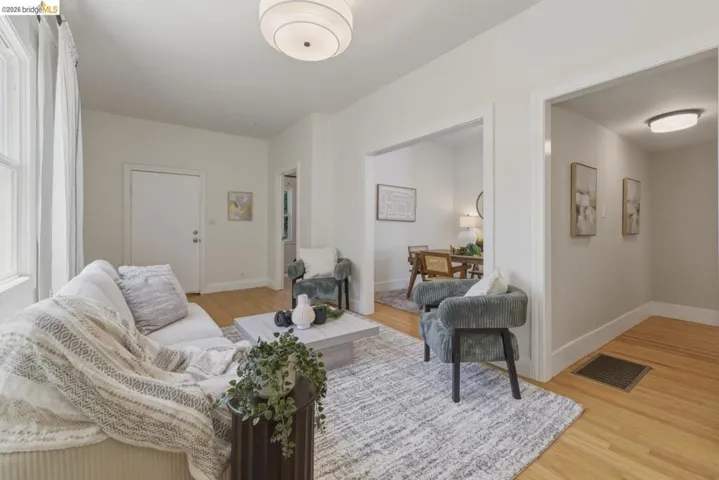 Living space featuring hardwood flooring, recessed entryways, and a semi-flush mount ceiling light
