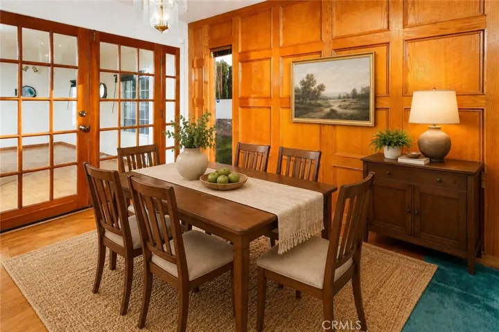 The dining area serves as a natural gathering spot with easy access to both the backyard and bonus room.  Photo is virtually staged.