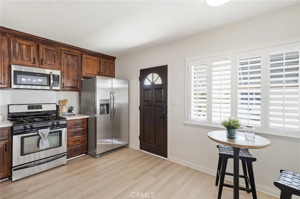 The remodeled family kitchen offers custom finished cabinetry, quartz countertops, stainless steel appliances, and a separate dining area - Perfect for everyday living and entertaining.