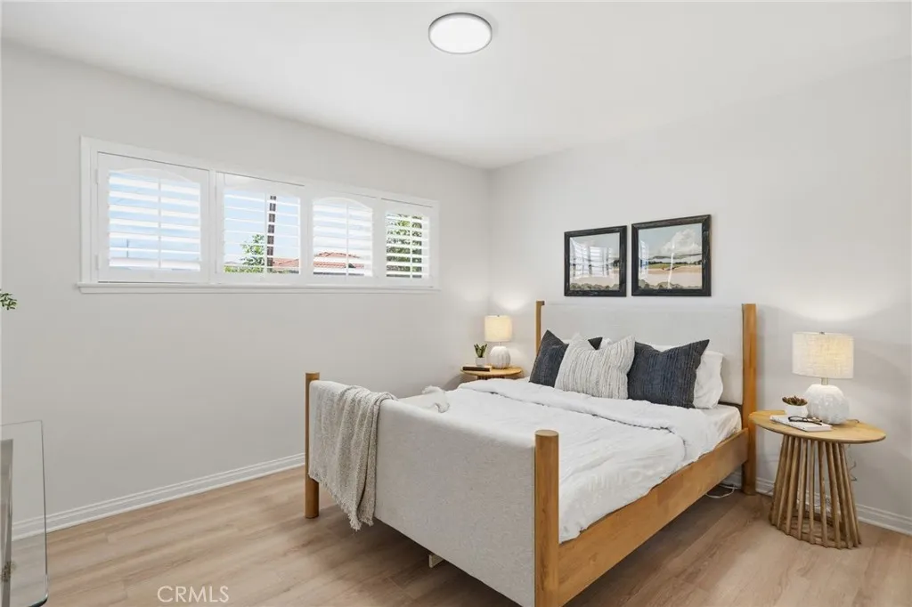 Primary Suite with luxury wide-plank vinyl-wood flooring, plantation shutters, fresh interior paint, and a private bath