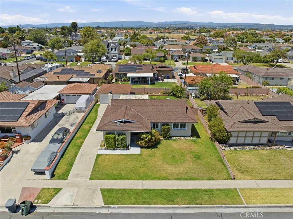 Situated on a spacious 6,490 square foot lot with a detached two-car garage, and extended driveway with parking for multiple vehicles.