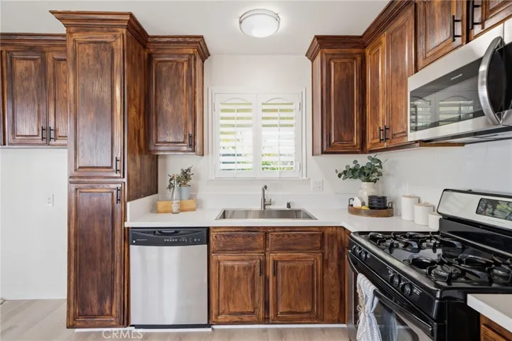 The remodeled family kitchen offers custom finished cabinetry, quartz countertops, stainless steel appliances, and a separate dining area - Perfect for everyday living and entertaining.