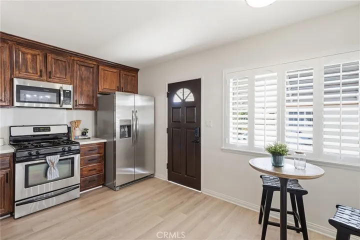 The remodeled family kitchen offers custom finished cabinetry, quartz countertops, stainless steel appliances, and a separate dining area - Perfect for everyday living and entertaining.