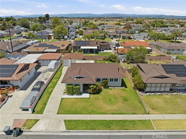 Situated on a spacious 6,490 square foot lot with a detached two-car garage, and extended driveway with parking for multiple vehicles.