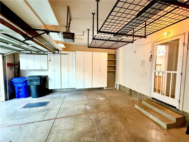2 car garage has storage cabinets and hanging storage unit