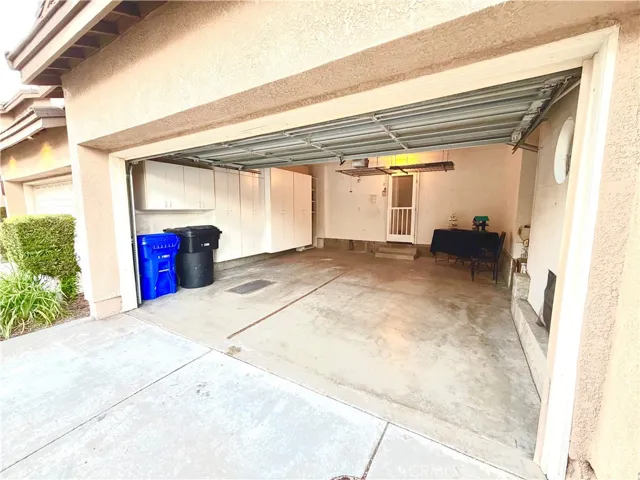 2 car garage with storage cabinets and hanging storage
