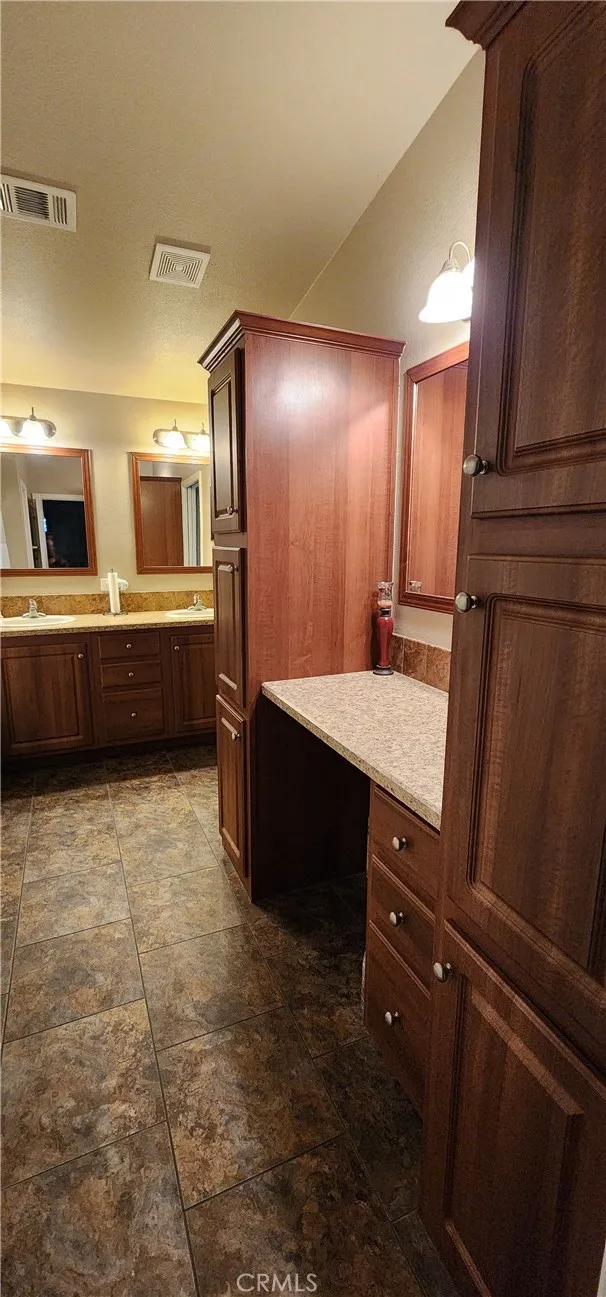 Primary bathroom with double sinks and separate vanity area