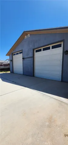 Back view of the garage and double (pull thru) roll-up doors