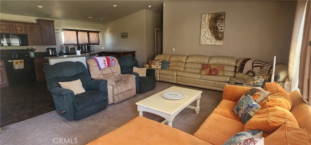 Living room with its open layout has plenty of room for family and guests