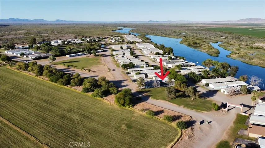 Aerial view of house in proximity to the resort and water