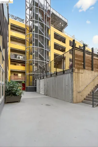 Multi-story building featuring a prominent spiral staircase with metal grates