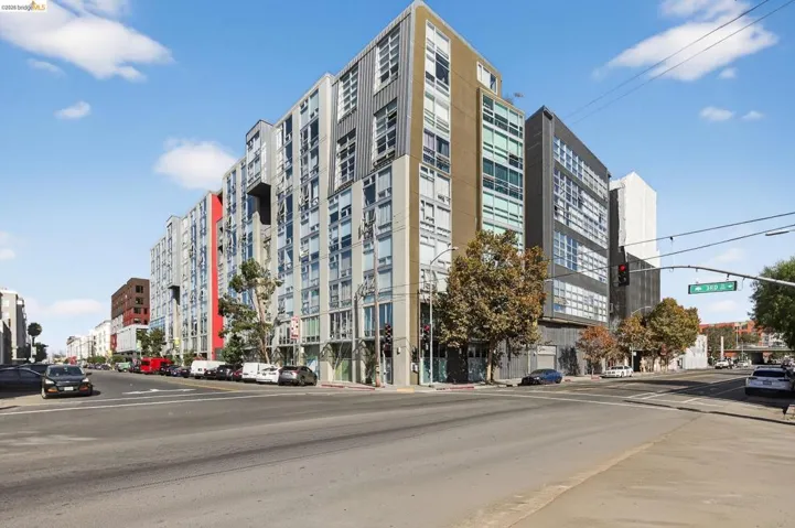 Modern multi-story building featuring a facade with varied paneling and numerous windows