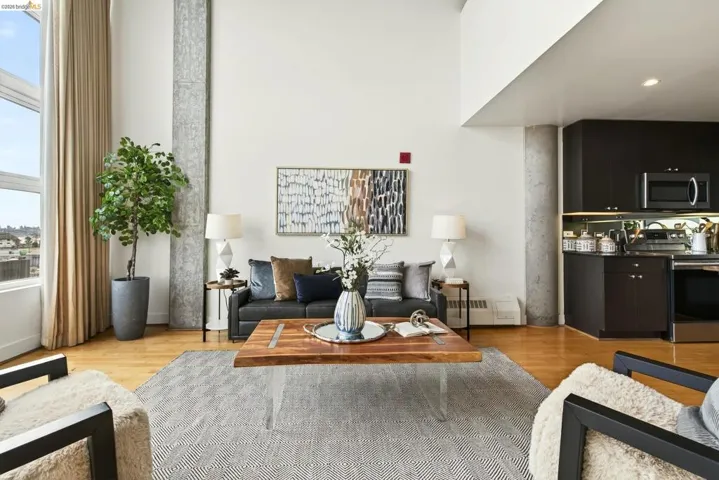Open-concept living area featuring high ceilings and light wood-finish flooring