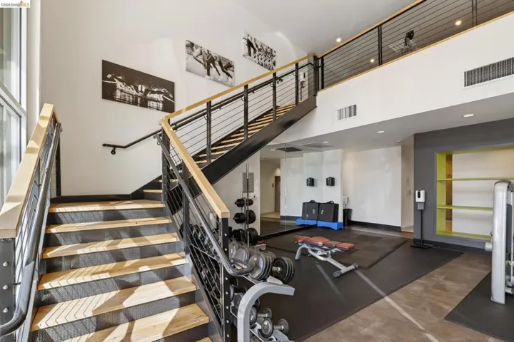 Two-story interior with a prominent staircase featuring wood treads and metal railings