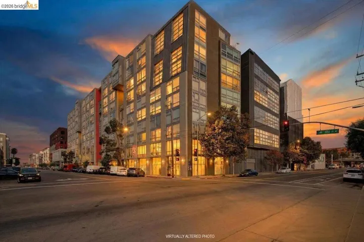 Modern multi-story building featuring extensive window-to-wall glass, a prominent corner presence, and a contemporary façade