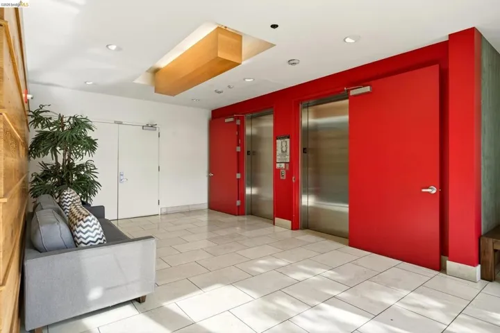 Lobby featuring tile flooring, recessed lighting, and a wood-paneled accent wall