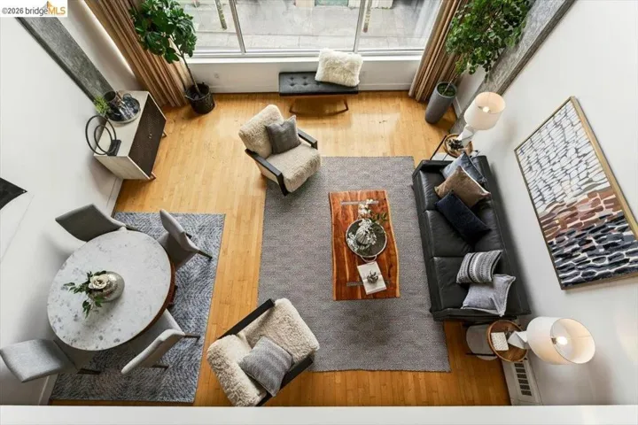 High ceilings complement wood-finish flooring throughout this open-concept living space