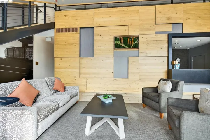 Lobby area featuring a wood-panel accent wall with integrated planters