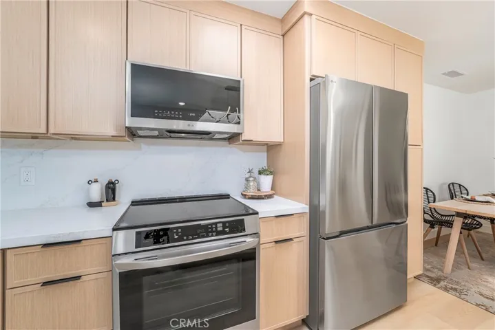 LG electric range with air fry option, microwave with vent to exterior, sleek refrigerator with water dispenser and ice maker, quiet dishwasher
