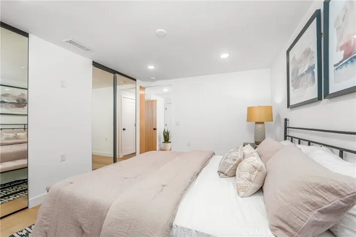 Primary suite with room for King size bed, dresser & nightstands, large closet with mirrored wardrobe doors, flat panel TV wall, recessed lights, ceiling fan prewire