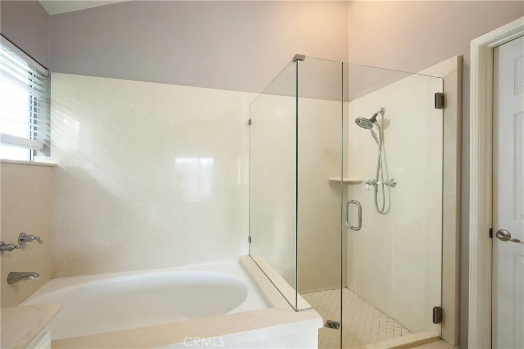 There is a tub and walk-in shower in the primary bathroom.