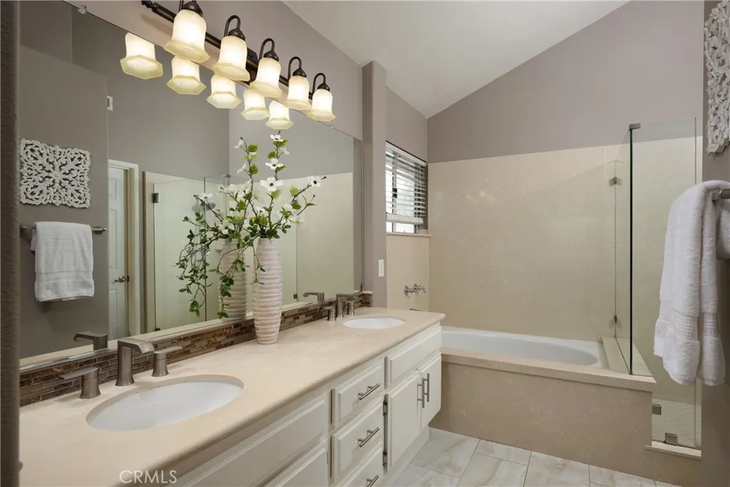 The primary bathroom features a dual vanity and walk-in closet.