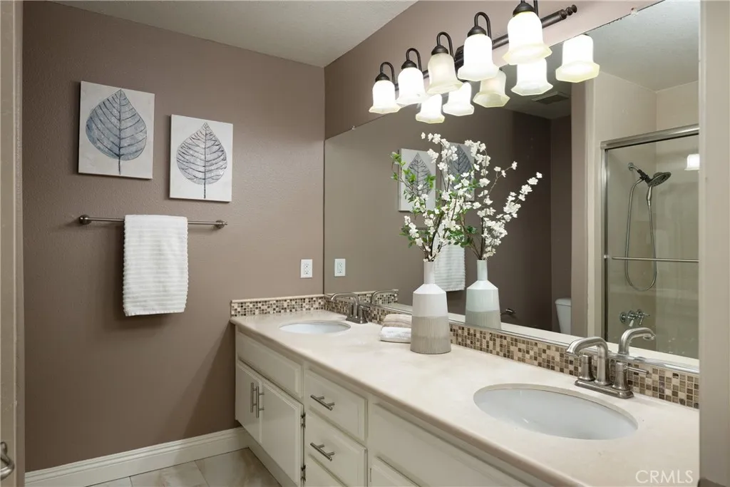 The two additional upstairs bedrooms share a guest bathroom with a dual vanity.