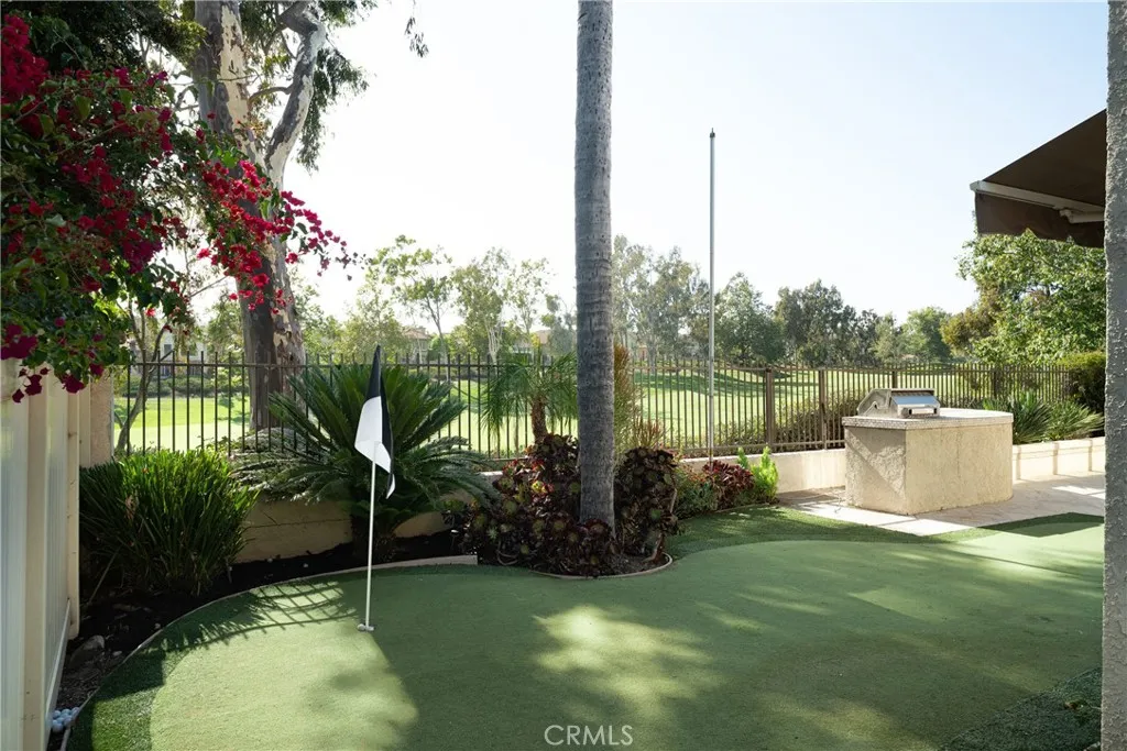 There is a putting green in the backyard.