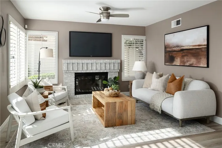 The family room has a fireplace and beautiful vinyl flooring.