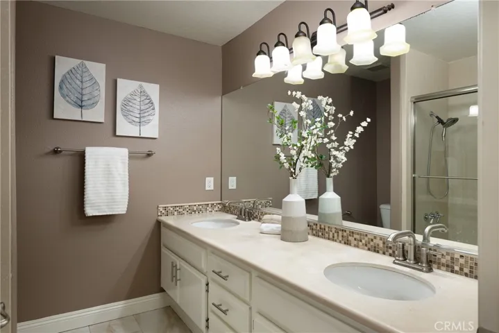 The two additional upstairs bedrooms share a guest bathroom with a dual vanity.