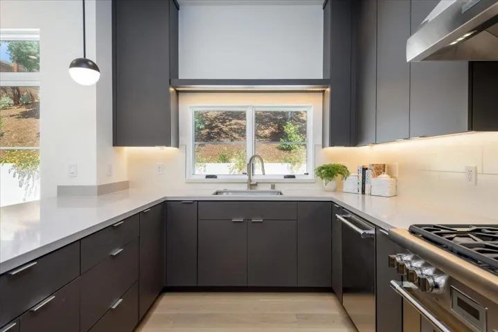 Beautifully defined over sink Window with lighted decirative shelving