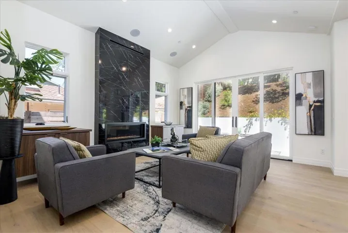 Soaring Ceilings, Showcase Windows, Blt in Cabinetry by wired for Big Screen TV Grand Fireplace Wall