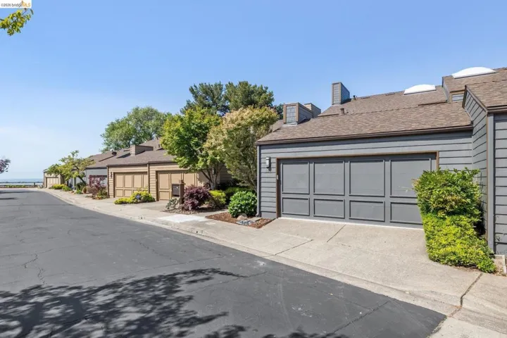 Exterior siding in a neutral gray tone with a paneled garage door