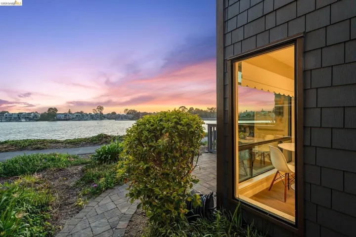 Exterior wall clad in dark shingle siding featuring a tall, slender window