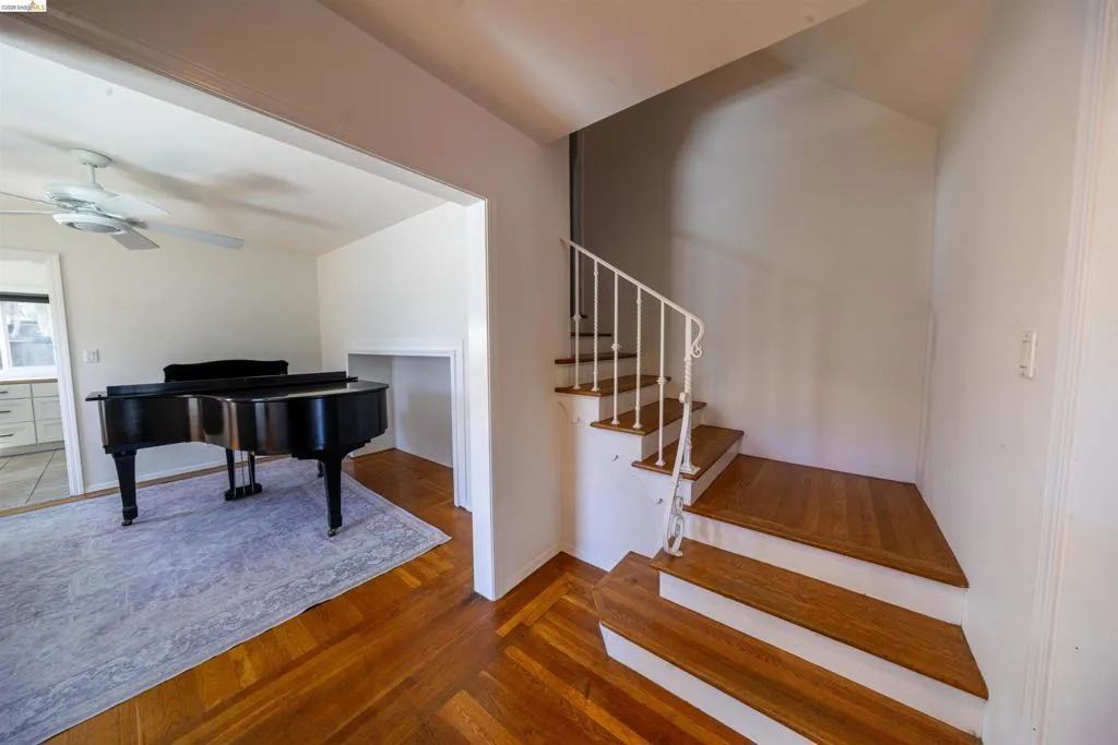 Hardwood flooring throughout the entry, staircase, and adjacent room