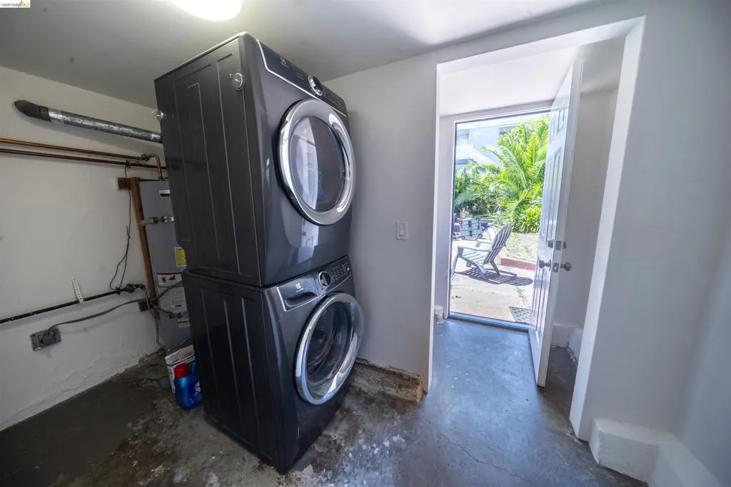 Dedicated laundry area featuring a stacked washer and dryer unit