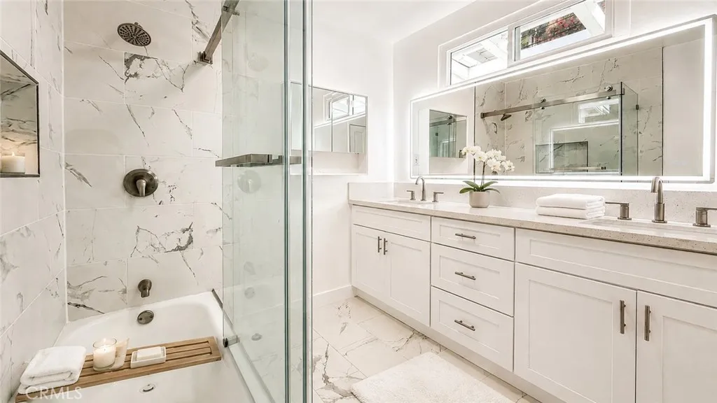 Bathroom — Virtually staged/enhanced with decorative accessories only. Towels, plants, candles, and accessories are not included. Original unstaged photo shown adjacent.