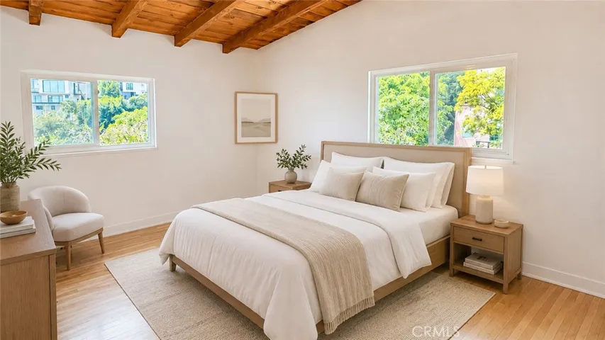 Secondary Bedroom — Virtually staged to show possible bedroom or guest room use. Furniture and decor are not included. Original unstaged photo shown adjacent.