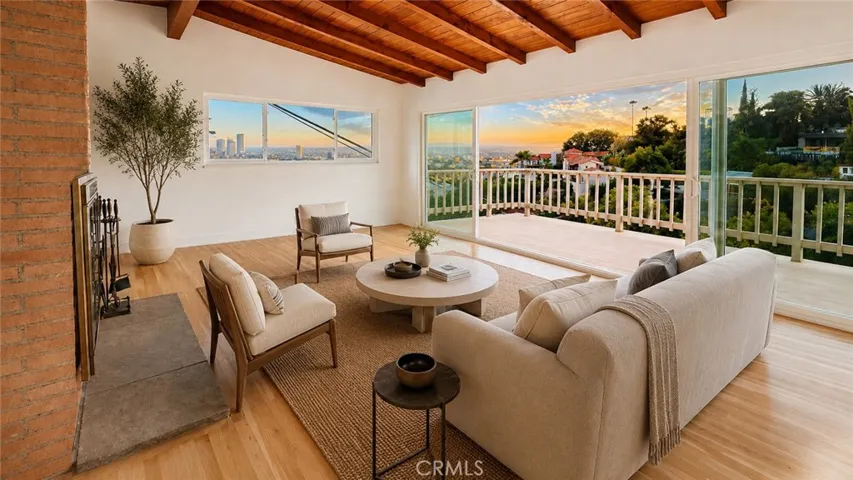 Living Room — Virtually staged to show possible furniture placement and scale. Furniture and decor are not included. Original unstaged photo shown adjacent.