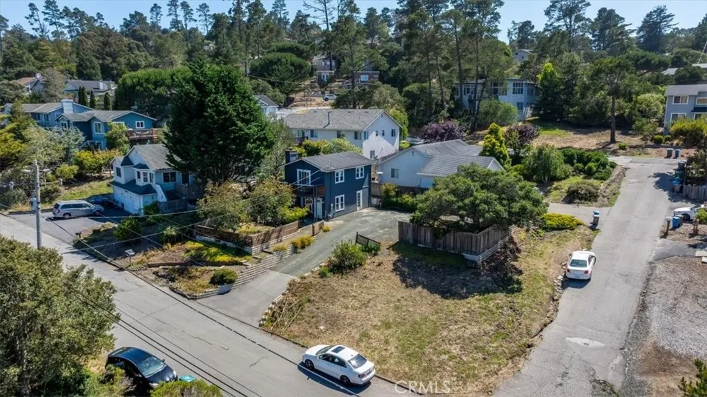 Higher aerial view showing corner of property.