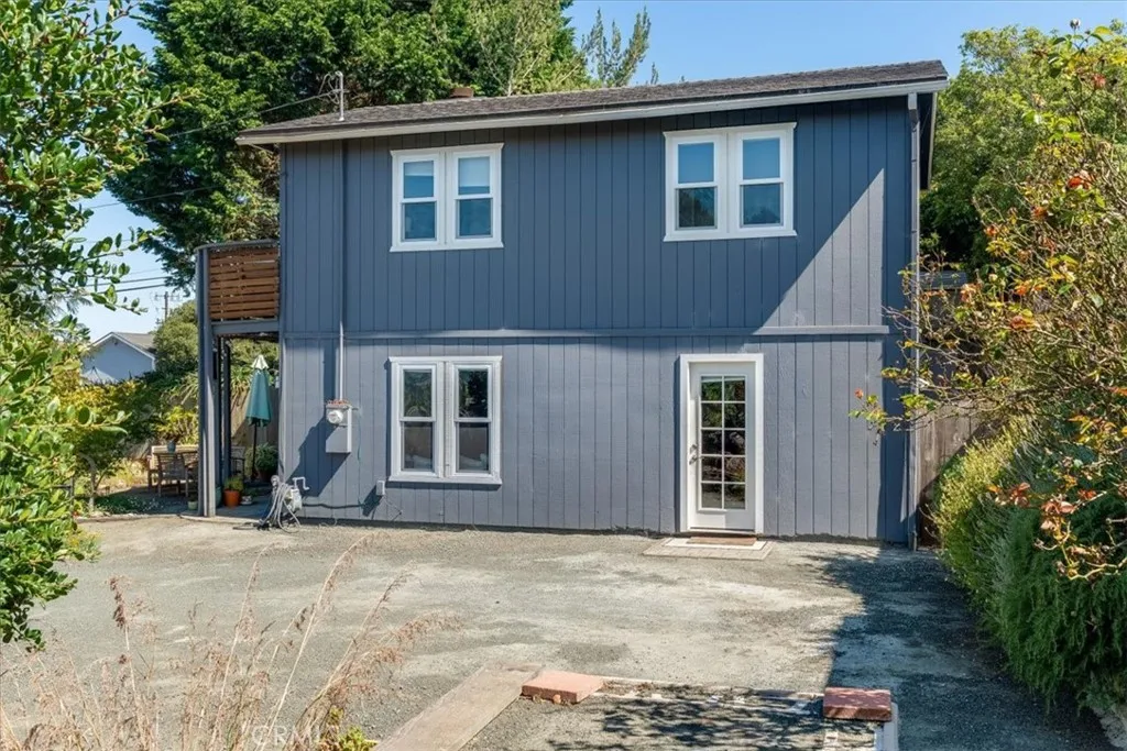 Side view of house showing side door and parking spaces.