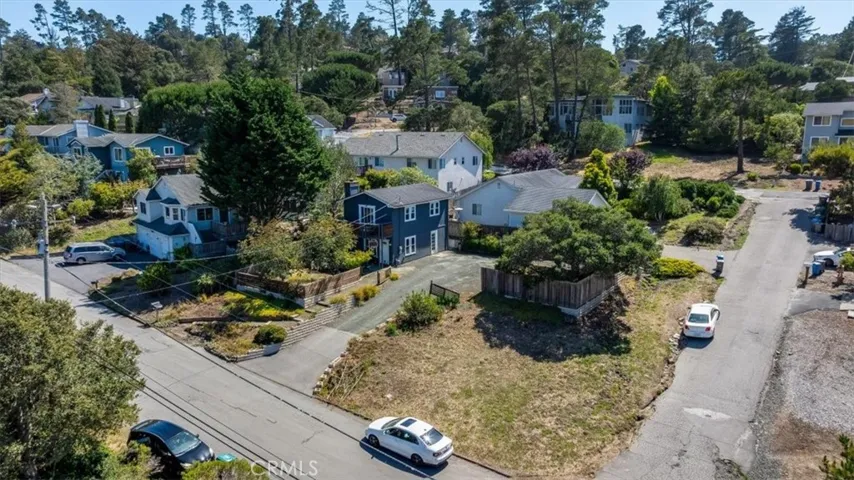 Higher aerial view showing corner of property.