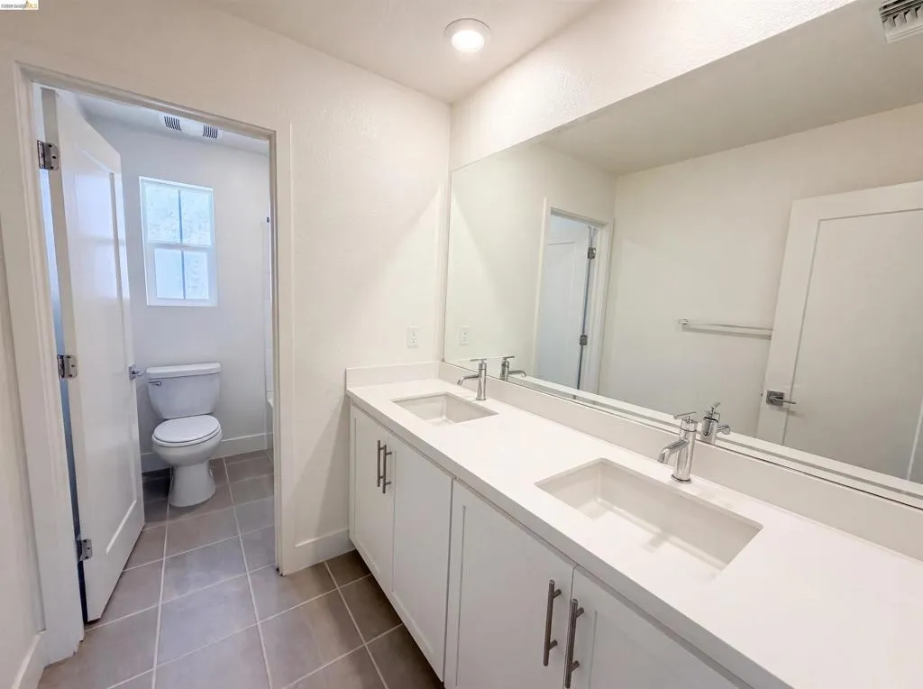 Double vanity with integrated rectangular sinks and chrome faucets
