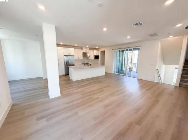 Spacious interior featuring wide plank wood-finish flooring throughout