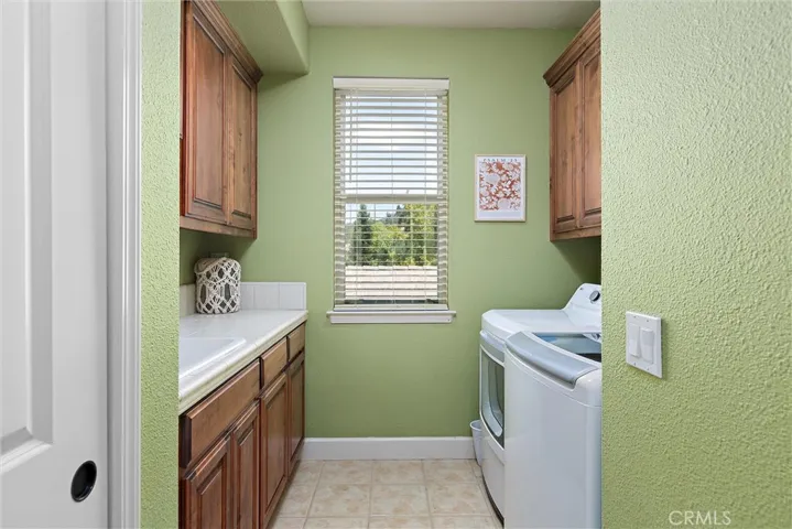 The upstairs laundry room has storage galore.